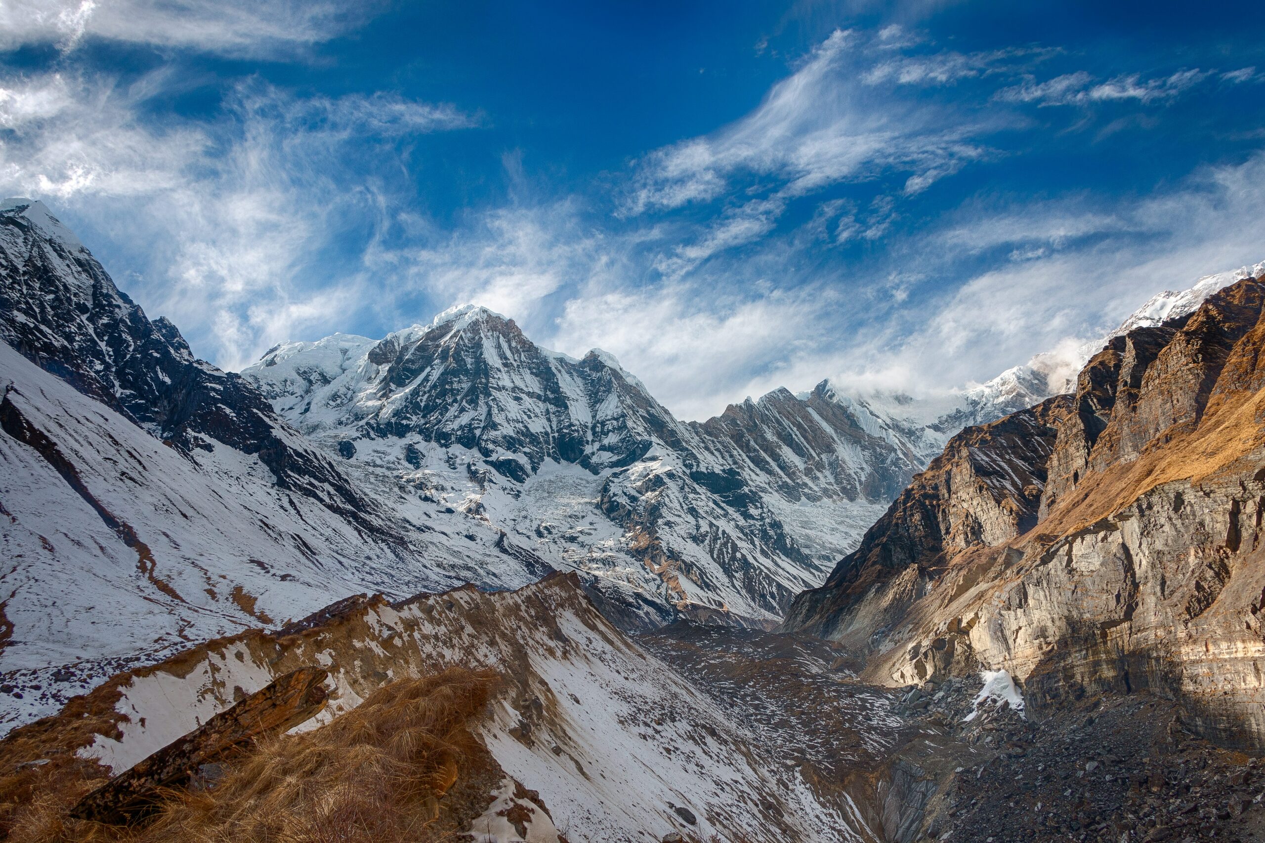 snow covered mountain under blue and white sky